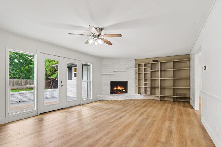 Bright main room with fireplace and shelving
