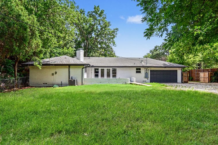 Rear exterior with lawn and trees